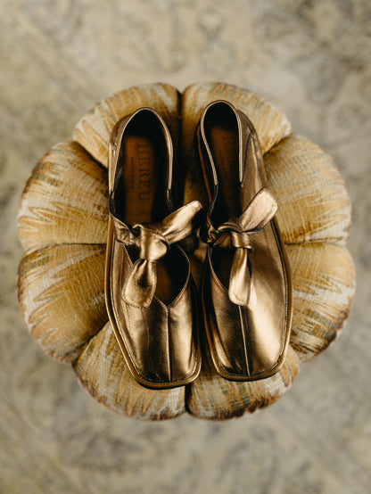 Llasada Metallic Front-Knot Gold Pumps